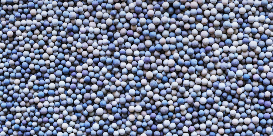 Ceramic material particles illustrating size variation relevant to mesh to micron conversion and raw material sizing